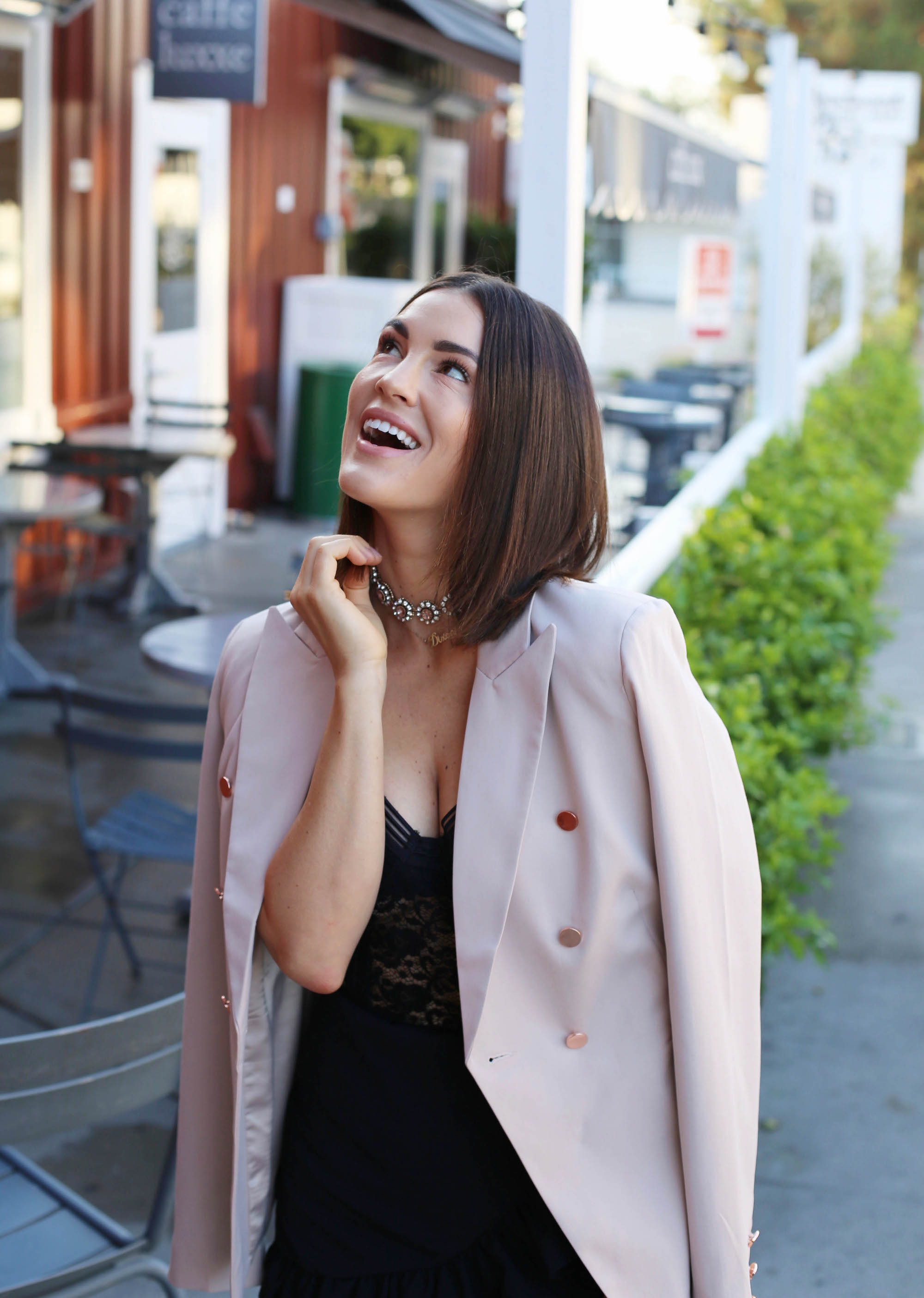 blush blazer and black outfit